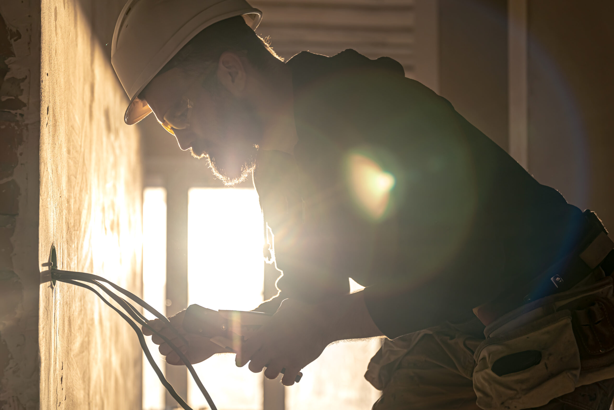 Licensed electrician cutting electrical wires during residential repair work